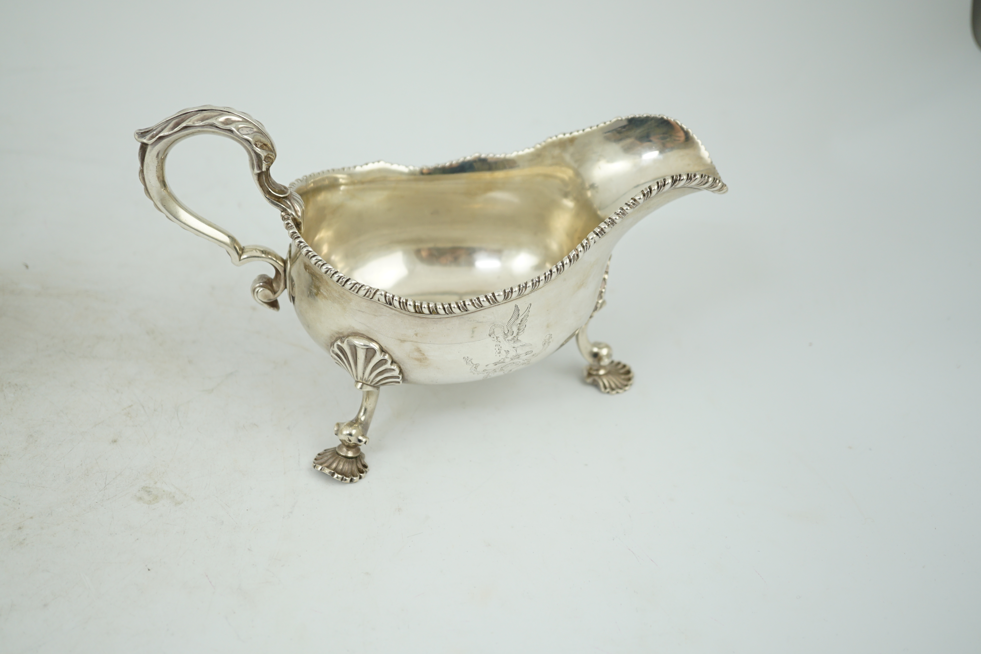 A George III silver sauce boat, with gadrooned border and shell knees, on fluted feet, Francis Crump, London, 1770, length 20.8cm, 13.9oz.